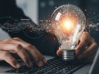 Close-up of hands typing holding glowing light bulb representing artificial intelligence automation and machine learning strategy
