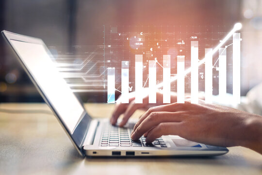 Close-up of hands typing on a laptop, with digital graphs and data visualizations emanating, illustrating concepts of analytics and business growth strategies. Impute - Powered by Adobe