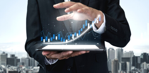 A businessman in a formal suit presents digital marketing data on a tablet, showcasing growth metrics against a stunning cityscape background. Impute