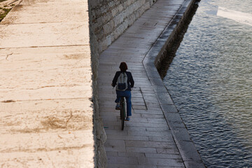 Woman riding bike in Pellestrina Island