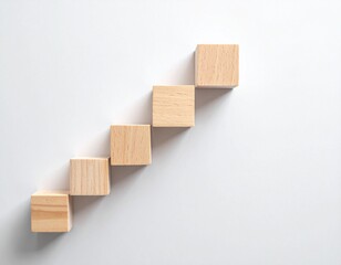 Wooden Blocks Arranged in an Ascending Staircase Pattern on White Background.