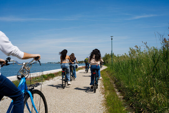 Tourist women riding bike in Pellestrina Island