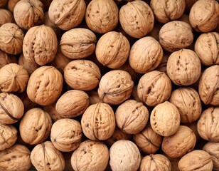Overhead shot of numerous shelled brown nuts, textured and tightly packed. A natural and unprocessed food item, perfect for healthy eating