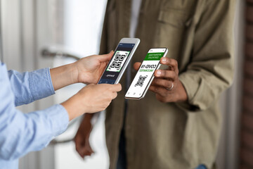 Vaccination Certificate. Black Man Showing Smartphone With Digital Health Passport, Showing Mobile App With QR Code To Female Worker On Entrance To Public Place, Confirming Covid-19 Negative Status