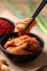 Kimchi cabbage in a bowl with chopsticks, Korean food