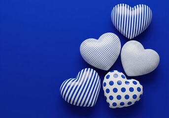 Five fabric hearts on blue background