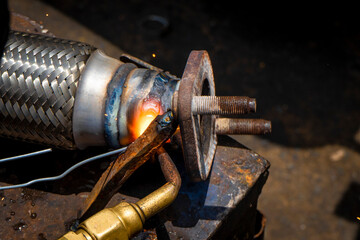 Person working in industry welding iron parts 