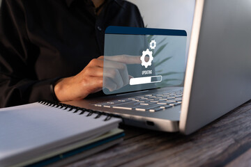 System or software update. Close-up of a hand pointing to a virtual loading progress bar interface and a gear icon.