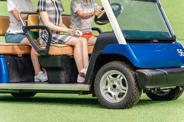 Female golfer riding a golf cart at a golf course (golf girl)