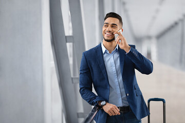Handsome Young Arab Businessman Talking On Cellphone While Waiting In Airport Terminal, Young...