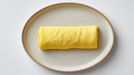 陶器の皿に美しく盛り付けられたきめ細やかな質感のふっくらと焼き上がっただし巻き卵