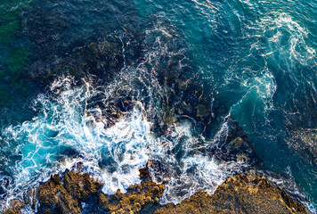 Tropical coastline. Blue ocean water waves. Sea waves from top. Summer rocky beach with beauty waves. Dramatic coastline. Ocean surf with waves. Ocean wave. Turquoise water coastline.