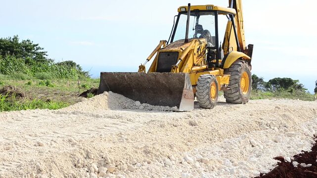 An Operator Using A Frontend Loader to Level Marl During A Roadway Construction