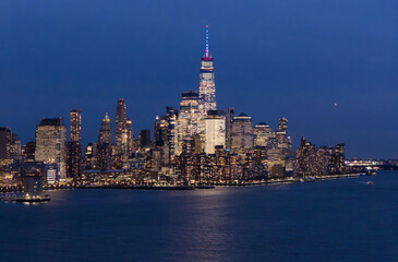 Obraz premium New York City skyline. NYC skyline with Hudson landscape. New York cityscape. New York City at night. NYC cityscape. NYC night metropolis skyline. New York City skyline with skyscrapers at night.
