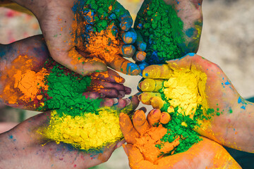Vibrant holi powder in hands. Festival of colors. Hands holding colorful holi powder. Bright...