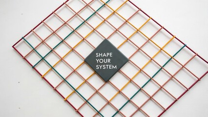 Creative geometric arrangement of colored straws with a motivational message on a square tile encouraging action