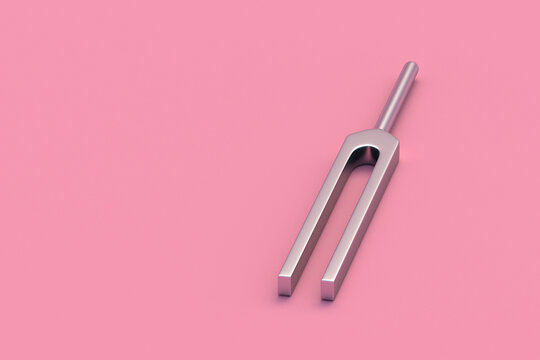 Tuning fork on pink background. Copy space. 3d render