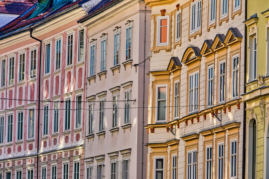 Rows upon rows of windows in late afternoon sunlight on side of residential housing apartments on a street in the old center of Ljubljana, Central Slovenia, Europe 