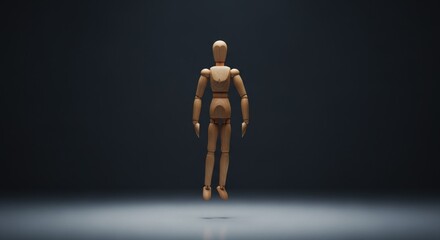 Wooden anatomical figure floats suspended in dark dramatic  lighting