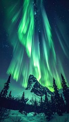 Spectacular green and blue aurora borealis over snowy mountain peaks
