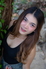 Naklejka premium Beautiful Asian woman model in a casual style with a vacation background
