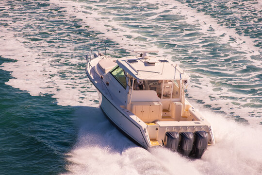 Luxury Fishing Motor Yacht With Three Outboard Engine Cruising at High Speed