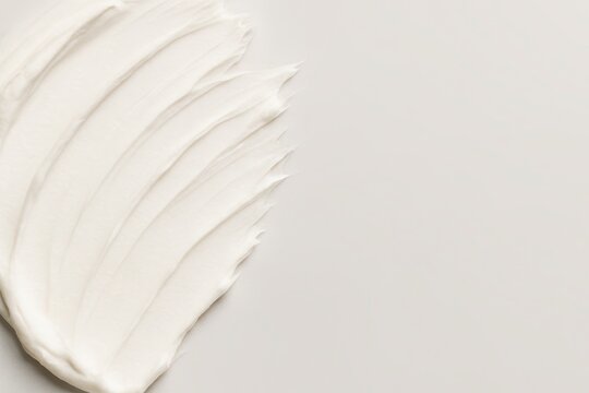Creamy Texture Strokes: Capturing the smooth, tactile essence of a cosmetic cream in a close-up, the image invites a sensory exploration of texture and purity.