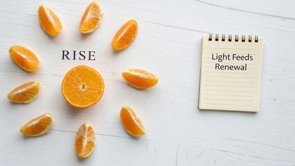 Fresh Orange Slices Arrange Around Text in Motivational Concept of Rise and Renewal on Light Background