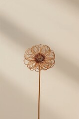 Flower made of wire is sitting on a white background