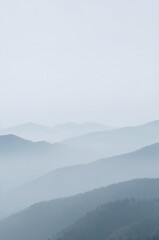The mountains are covered in a thick layer of fog, creating a serene