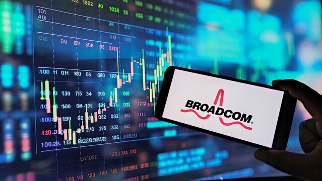 Hand holding smartphone with Broadcom logo on screen displaying stock market data