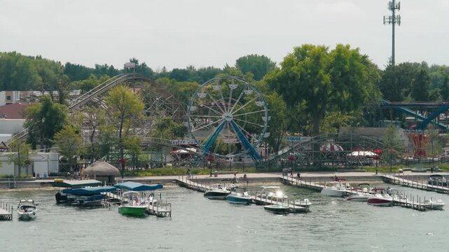 Slow push in aerial shot of Arnolds Park in Okoboji Iowa over the lake.