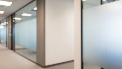 Blurred office hallway with glass walls and white pillars