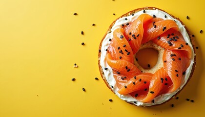 Close up photo of bagel with cream cheese and salmon. Toasted bagel sandwich on yellow backdrop. Delicious breakfast meal with fresh ingredients. Tasty snack for morning or lunch.