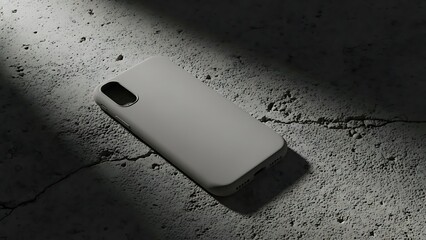 A smartphone case lies on a cracked concrete floor illuminated by a beam of light from above
