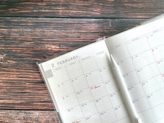 February schedule book on a wooden table
