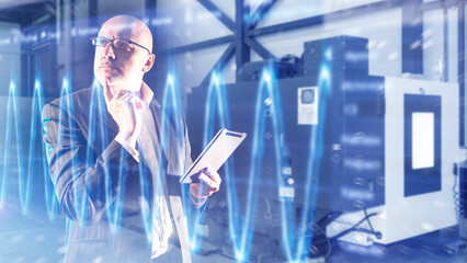 Industrial diagnostics evaluates machine performance as an engineer analyzes vibration data on a tablet to detect faults and optimize equipment operation.