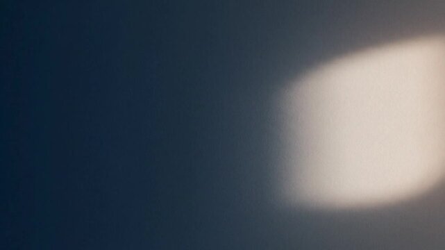 Close-up shot of a blurred light source against a dark background with a shallow depth of field.