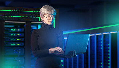 IT security, cybersecurity analyst manages server networks with a laptop to protect data and maintain reliable digital infrastructure inside a data center.