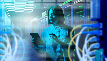 Data center operations, IT specialist monitors cloud servers and network connections with a tablet to manage secure digital infrastructure and system performance.