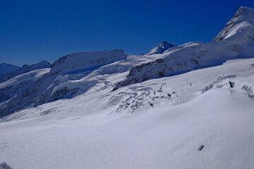 Jungfrau glaciers and deep crevasses under a clear blue sky