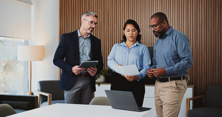 Office, business people or reading document for review, evaluation or assessment of investment proposal. Meeting, tech or risk management team with trading project form, check profitability or budget