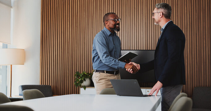 Shaking hands, deal and business men in office for partnership, agreement or collaboration. Happy, meeting and male financial advisor with client for investment contract with handshake in workplace.