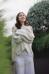 Young woman embracing self love outdoors feeling serene