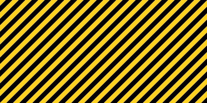 Yellow and black diagonal hazard warning stripes background. Industrial safety sign pattern for caution area, construction site, or under maintenance barrier.