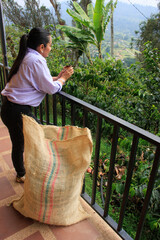 Woman drinking coffee while enjoying mountain view at coffee plantation