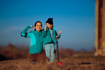Mother and Little Girl Practicing Sports together Outside. Cheerful family working out as a team feeling motivated 

