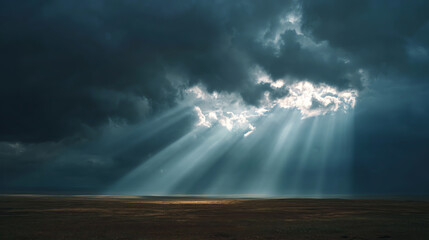 Dramatic clouds parting to reveal rays of sunlight shining through, creating a breathtaking view of the landscape.