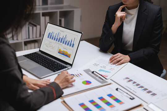 Businesswomen analyzing financial data and marketing reports