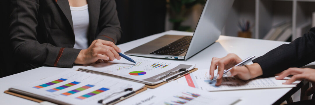 Businesswomen analyzing financial data, planning company strategy - Powered by Adobe